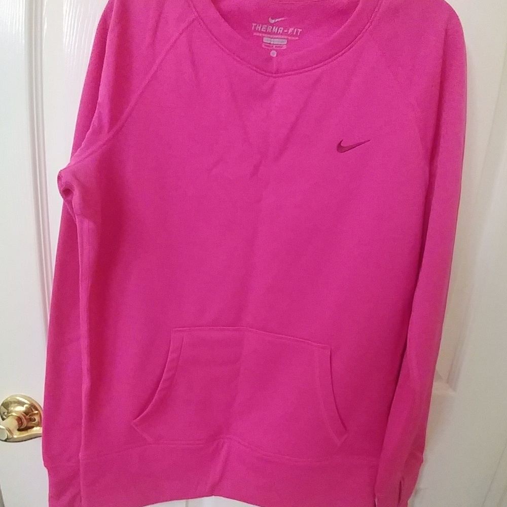 A pink nike therma-fit pullover sweatshirt
